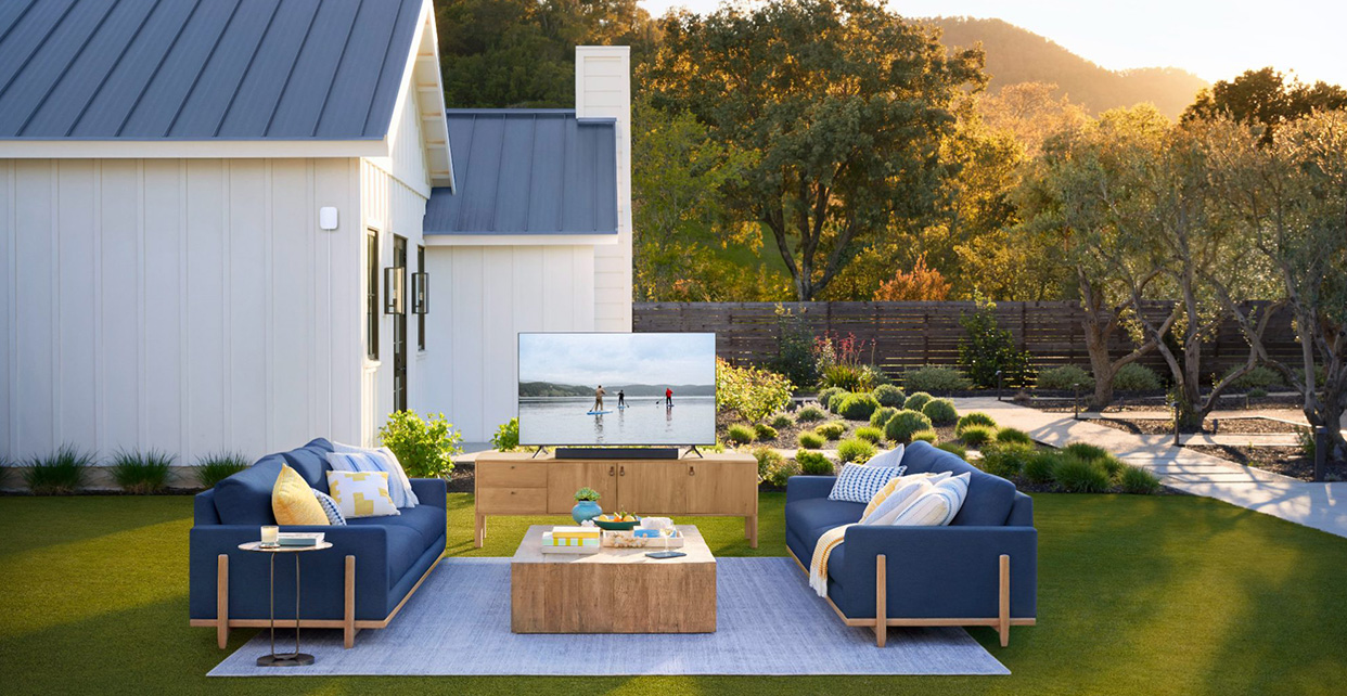 Outdoor living room on the lawn with a TV streaming