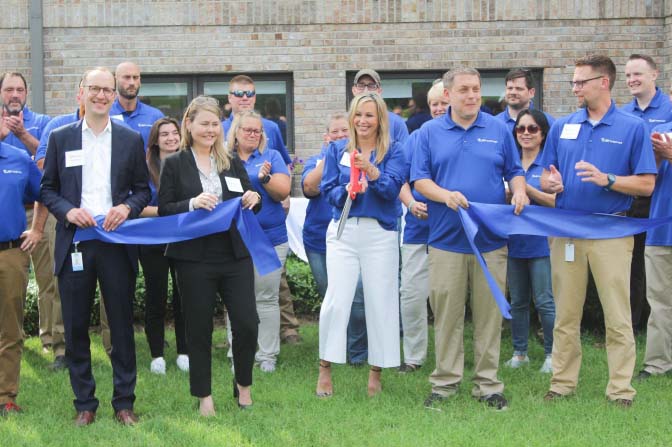 The Surf Internet team celebrates after cutting the ribbon on their second Elkhart office location which will serve as the company’s new headquarters.